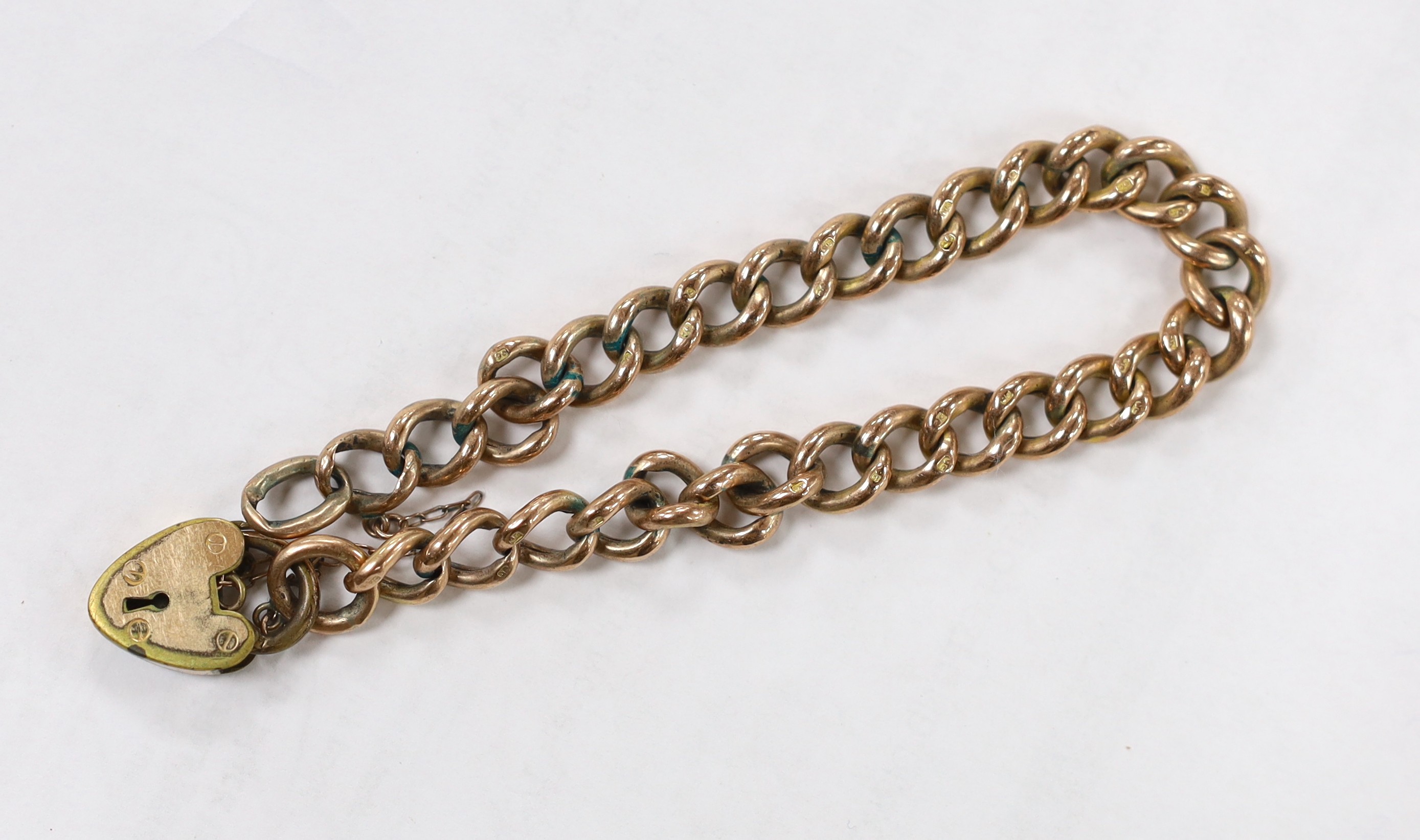 A 9ct curb link bracelet with gold plated heart shaped padlock clasp, 19.5cm, gross weight 10.8 grams.